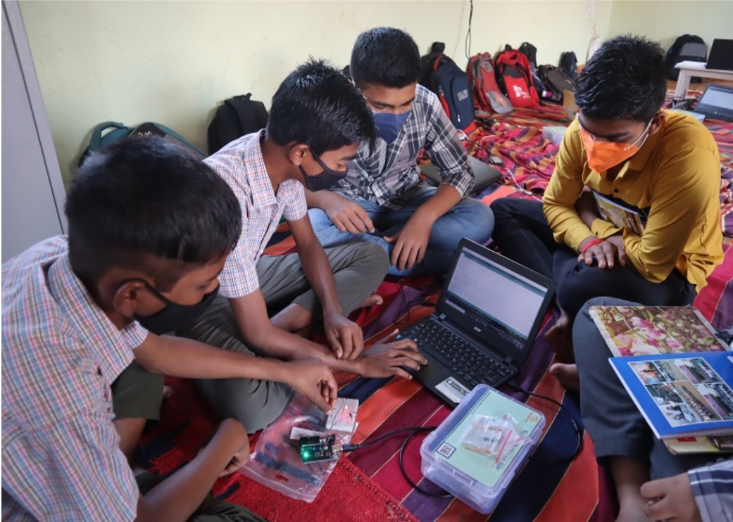 Rural students learning electronics with a laptop